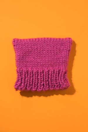 high angle view of a homemade pink knit hat, known as pussycat hat or pussyhat, because of the...