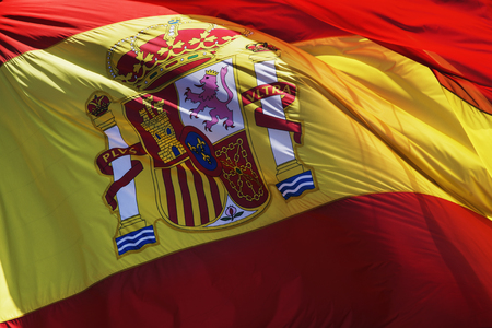 the flag of spain waving on the windの写真素材