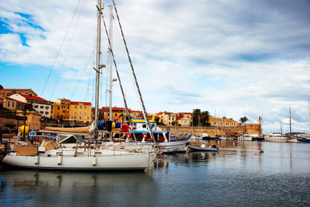 ALGHERO, ITALY -SEPTEMBER 18, 2017: A view ove the port of Alghero, Sardinia, Italy, next to the walls of the Centro Storico, the old town of the cityのeditorial素材