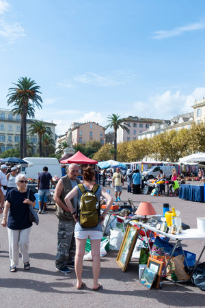 BASTIA, FRANCE - SEPTEMBER 16, 2018: People buying on a street market installed every Sunday on the Place Saint-Nicolas square in Bastia, Corsica, Franceのeditorial素材