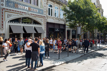 PORTO, PORTUGAL - AUGUST 29, 2018: A line of people waiting to walk into the famous old Livraria...