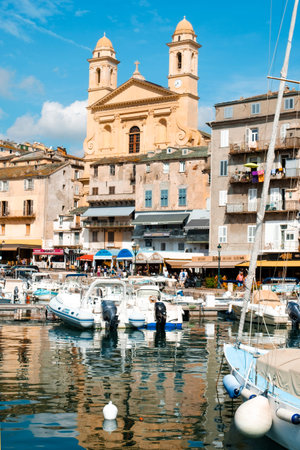 BASTIA, FRANCE - SEPTEMBER 16, 2018: A view of the Vieux Port, the Old Port of Bastia, in Corsica, France, highlighting the Saint-Jean-Baptiste Church with its characteristic twin bell towersのeditorial素材