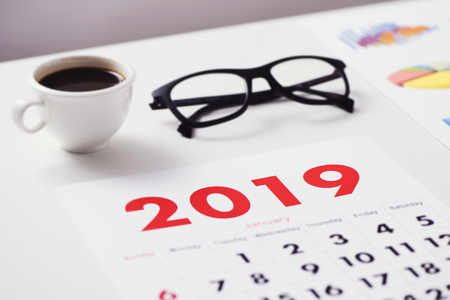 Closeup of a calendar of 2019 on a white office tableの写真素材