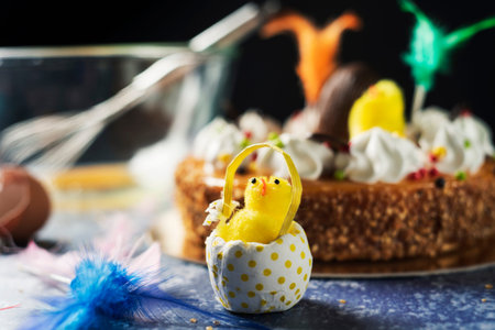 closeup of a plush chick on a table and a typical mona de pascua, a cake eaten in Spain on Easter...