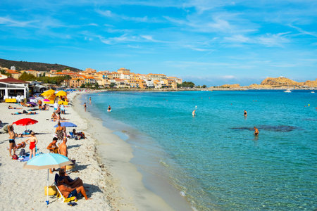 ILE-ROUSSE, FRANCE - SEPTEMBER 22, 2018: People sunbathing and bathing on the beach in Ile-Rousse,...