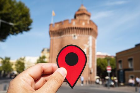 closeup of the hand of a caucasian man holding a red marker at Le Castillet fortress in Perpignan, Franceの写真素材