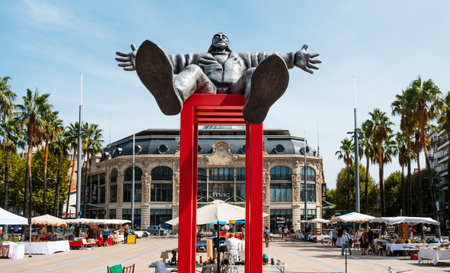 PERPIGNAN, FRANCE - SEPTEMBER 14, 2019: Catalogne Square in Perpignan, France, highlighting a statue of Dali in the foreground and the Aux Dames de France, a former department store, in the backgroundのeditorial素材