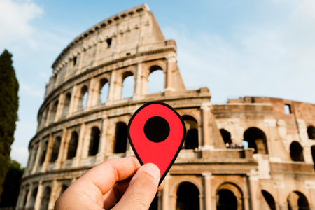 closeup of the hand of a caucasian man holding a red marker at the famous Flavian Amphitheatre or...