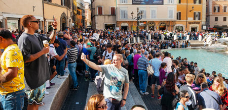 ROME, ITALY - OCTOBER 13, 2019: A crowd of tourists at the famous Trevi Fountain or Fontanta di Trevi, in Rome, Italy, taking pictures or waiting to throw their coins to itのeditorial素材