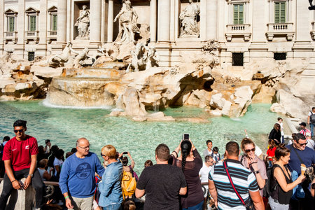 ROME, ITALY - OCTOBER 13, 2019: A crowd of tourists at the famous Trevi Fountain or Fontanta di Trevi, in Rome, Italy, taking pictures or waiting to throw their coins to itのeditorial素材