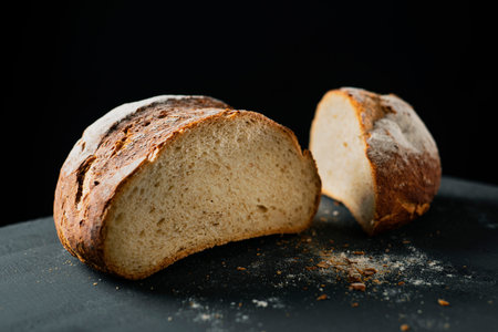 a pan de payes, a round bread typical of Catalonia, Spain, on a dark green surface