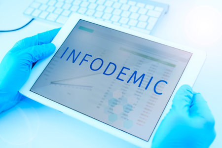 Closeup of a doctor man, wearing blue surgical gloves, having a digital tablet in his hands with the...