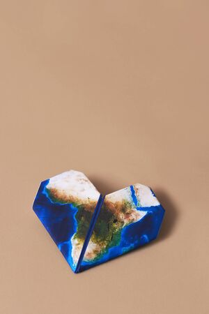 Origami heart, patterned with a map of Africa  on a brownの写真素材