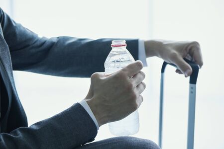 Closeup of a young businessman sitting in the waiting hallの写真素材