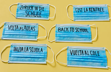 surgical mask with the text back to school written in german, english, portuguese, french, italian...