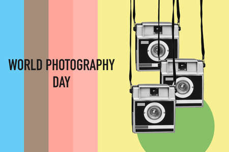 some retro film cameras, in black and white, and the text world photography day on a background of stripes of different colorsの写真素材