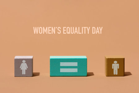 a building block with a woman symbol, another one with an equals sign and another one with a man...