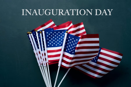 the text inauguration day and some american flags on a dark gray background