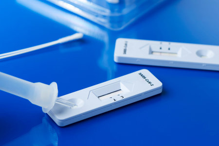 some covid-19 rapid antigen test kits, with the diagnostic test devices and some nasopharyngeal...