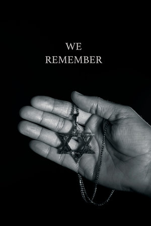 closeup of an old and rusty pendant in the shape of the star of david on the hand of a man and the...