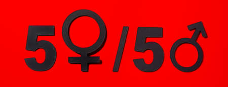 a depiction of the gender equality concept, with the expression 50-50 depicted with the gender symbols in black on a red background, in a panoramic format to use as web banner or headerの写真素材