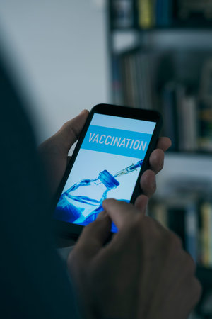 closeup of a young caucasian man, at his living room, watching at his smartphone, with text...