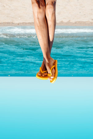 Closeup of the legs of a young caucasian man on the beach wearing a pair of yellow flip-flops,...