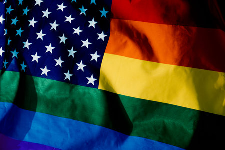 closeup of a rainbow US flag waving on the sky, moved by the wind