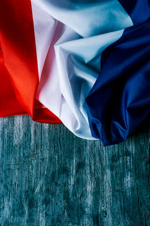 closeup of a french of flag on a gray rustic wooden backgroundの写真素材