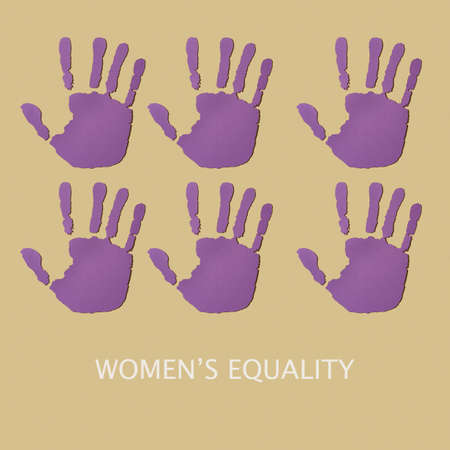 Womens equality and some hands cut out in a violet paperの写真素材