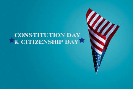 the text constitution day and citizenship day, and a flag of the United States against a blue backgroundの写真素材