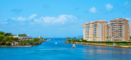 a view of the inner side of la Gola del Puerto canal, in La Manga del Mar Menor, Murcia, Spain, facing the Mar Menor lagoon, in a panoramic format to use as web banner or headerの写真素材