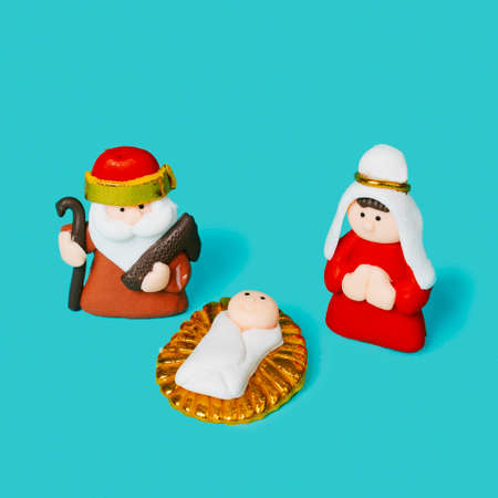 the holy family, formed by the child jesus, the virgin mary and saint joseph, on a blue backgroundの写真素材