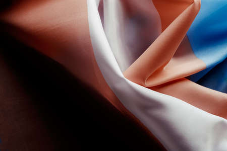 closeup of a draped silky transgender pride flag, with a soft lightの写真素材