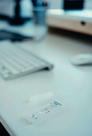 a covid-19 antigen diagnostic test device with a negative result on the white desk of an office