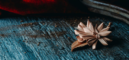a Spanish braided palm leaf, typically blessed on Palm Sunday, on a rustic wooden surface, in a...