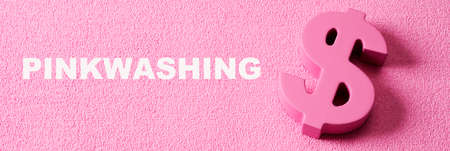 text pinkwashing and a pink dollar sign on a pink textured background, in a panoramic format to use as web banner or headerの写真素材