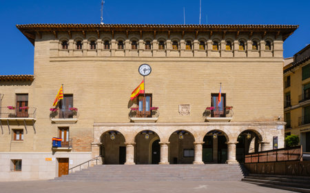 Monzon, Spain - June 28, 2022: The facade of the historic Ayuntamiento or Casa Consistorial, the city hall, of Monzon, in Huesca, Aragon, Spain, in the Plaza Mayor square, in the old town of the cityのeditorial素材