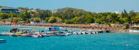 Vouliagmeni, Greece - September 1, 2022: A panoramic view of the Vouliagmeni beach in Vouliagmeni, Greece, in a summer dayのeditorial素材