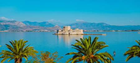 a view of the Bourtzi castle in Nafplio, in the Aegean sea, in Greece, in a panoramic format to use as web banner or headerの写真素材
