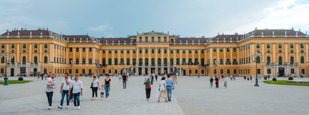 Vienna, Austria - August 28, 2022: Some people walking by the square that leads to the entrance to the Schonbrunn Palace in Vienna, Austria, in a panoramic formatのeditorial素材