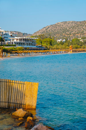 Vouliagmeni, Greece - September 1, 2022: Detail of Vouliagmeni beach, in Greece, where some people enjoy the good weather of a summer dayのeditorial素材