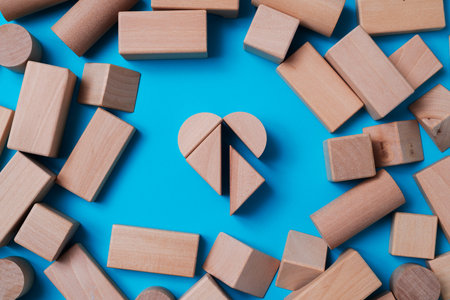 high angle view of some wooden building blocks forming a heart in the center of some other building...