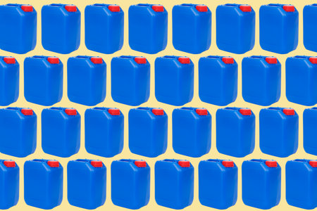 some blue plastic jerrycans, with red caps, arranged in different lines on a pale brown or pale green backgroundの写真素材