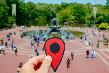 closeup of the hand of a man holding a red marker pointing Bethesda Terrace, in Central Park, New York City, United States, on a sunny spring dayの写真素材