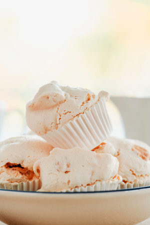 closeup of some merengues almendrados, spanish baked meringues with almonds, in a white ceramic bowl