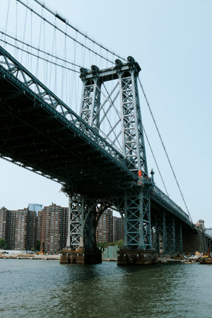 a view of the Williamsburg Bridge, over East River, facing Lower East Side, in Manhattan Island, New York City, United States, on a spring dayの写真素材