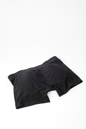 a pair of black boxer briefs with bottom padding on a white background with some blank space on topの写真素材