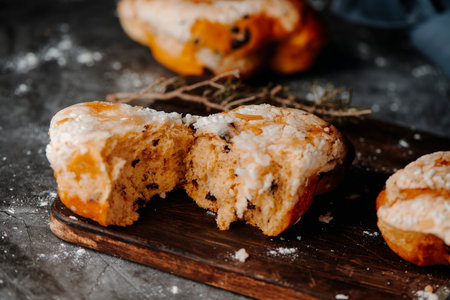 a colomba pasquale, a typical italian easter bread, split on half on a wooden cutting board, next to some more colombe pasqualiの写真素材