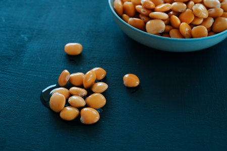 closeup of some altramuces, lupinus albus beans, cooked and pickled in brine, a typical snack in...